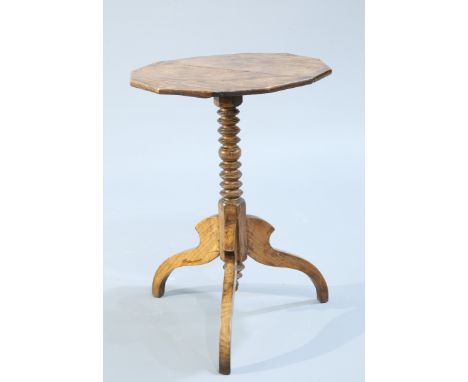 AN OAK TRIPOD TABLE, the well-figured twelve sided top raised on a ring turned stem continuing to hipped downswept legs. 68.5