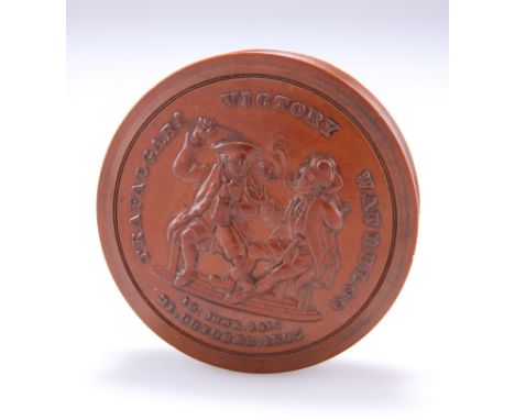 TRAFALGAR AND WATERLOO
AN IMPRESSED FRUITWOOD SNUFF BOX, BY JOHN WESTWOOD, CIRCA 1815, circular. Diameter 7cm