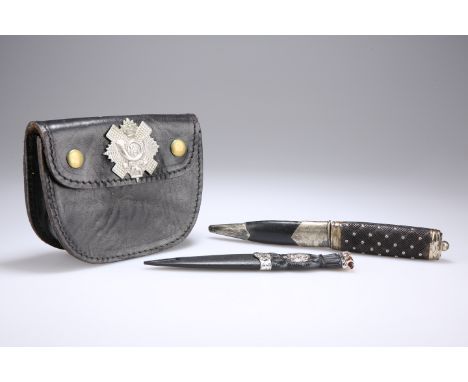 A BLACK LEATHER WAIST BELT POUCH WORN BY LOWLAND REGIMENTS, with two stud fasteners to front and belt loops to reverse, this 