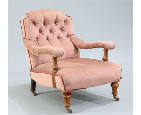 A VICTORIAN WALNUT AND UPHOLSTERED COUNTRY HOUSE ARMCHAIR, with button back and arms, raised on turned legs and moving on bra