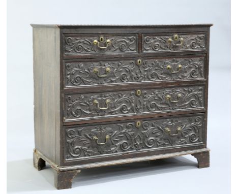 A GEORGE III OAK CHEST OF DRAWERS, later carved, the rectangular top above two short over three long graduated drawers, each 