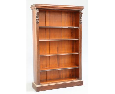 A VICTORIAN MAHOGANY OPEN BOOKCASE, with leaf and fruit carved corbels, raised on a plinth base. 147.5cm high, 92.5cm wide, 2