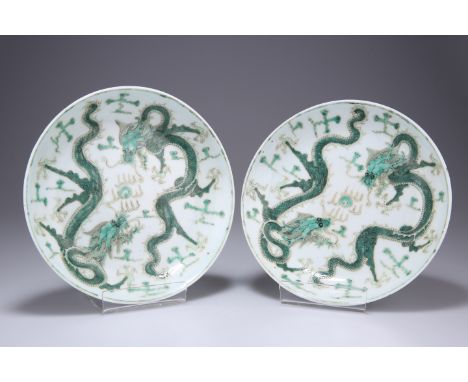 A PAIR OF CHINESE FAMILLE VERTE PORCELAIN DISHES,&nbsp;circular, each painted with opposing four clawed dragons chasing a fla