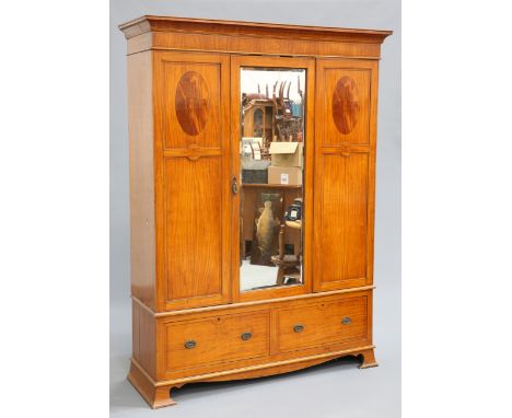 A LATE VICTORIAN SATINWOOD WARDROBE, with concave pediment over a central mirror door flanked by oval panels, the base fitted