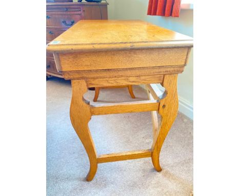 A light oak side table on trestle shaped base with drawer and slide to frieze, 32" wide