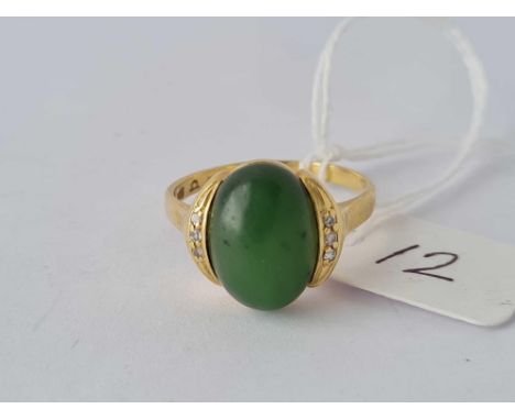 A vintage green stone ring with three diamonds mounted on each side 14ct gold size T – 5 gms