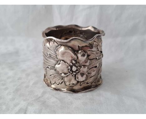 An unusual wide napkin ring chased with pansies dated 1904, 2" deep 