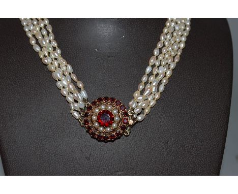 A FIVE ROW SEED PEARL NECKLACE with gold circular AMETHYST AND SEED PEARL CLASP.