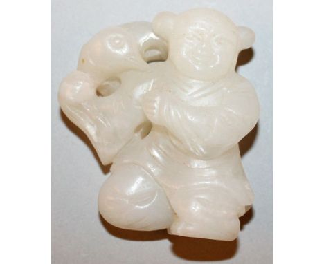 A 19TH CENTURY CHINESE WHITE CELADON JADE CARVING OF A KNEELING BOY, a bird perched on one shoulder, 2in high.