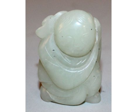 A LATE 19TH/EARLY 20TH CENTURY CHINESE CELADON JADE CARVING OF A KNEELING BOY, bearing a frond of lingzhi over his shoulders,