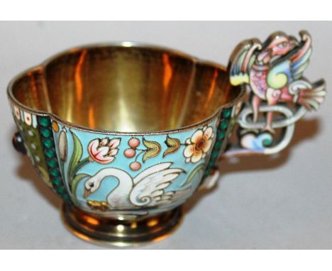 A SMALL RUSSIAN SILVER AND ENAMEL KOVSH with two panels of swans and pierced bird handle, 3.5ins long, stamp 875, 84 head to 