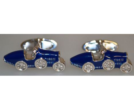 A PAIR OF SILVER AND ENAMEL CAR CUFFLINKS.