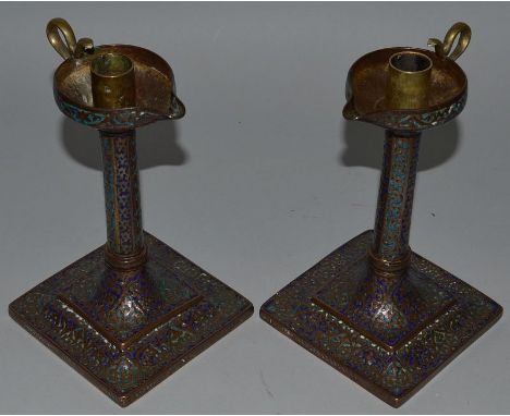 A GOOD PAIR OF COPPER AND BLUE ENAMEL CANDLESTICKS formed as oil lamps on square bases. 8ins high.