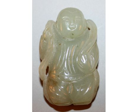 A 20TH CENTURY CHINESE CELADON JADE CARVING OF A STANDING BOY, a length of cloth draped around his shoulders, 2.3in high.