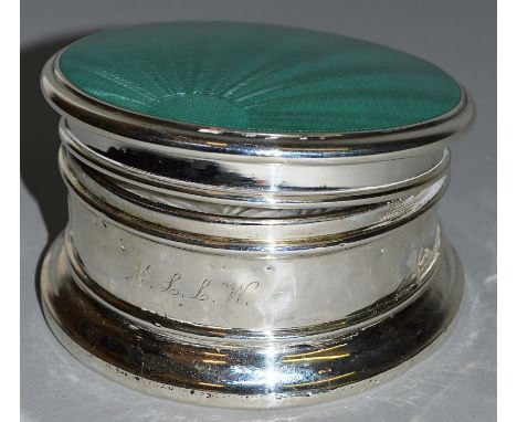 A SILVER COMPACT with enamel top.