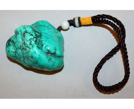 A CHINESE TURQUOISE-LIKE PENDANT, of boulder form, with attached tassel, the pendant 2.4in wide & 2.1in high.