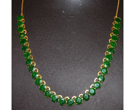 A 20ct GOLD AND JADE SET NECKLACE.