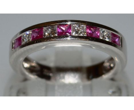 A RUBY AND DIAMOND RING in white gold.