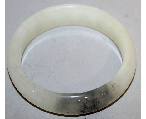 A CHINESE WHITE JADE BANGLE, 2.7in diameter.