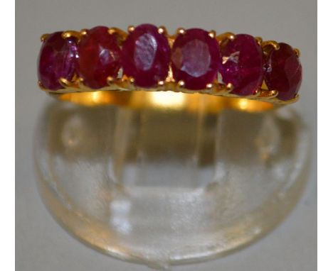 A GOOD SIX STONE RUBY HALF HOOP RING asset in 20ct gold.