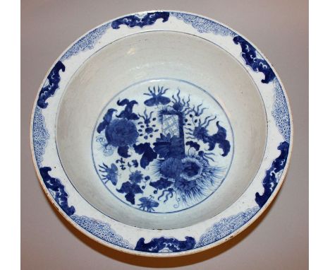 A CHINESE BLUE & WHITE PORCELAIN BASIN, decorated to its interior centre with butterflies hovering near flowers and leafage, 