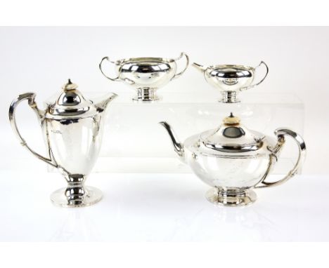 George V silver four piece tea service, comprising teapot, hot water jug, cream jug and sugar bowl, with scroll handles on ro