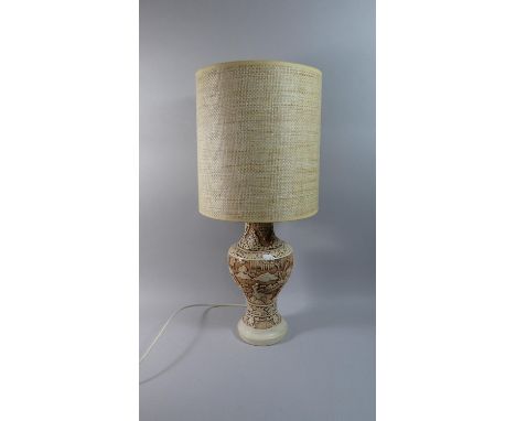 An Oriental Relief Decorated Table Lamp and Shade Depicting Figures in Mountainous Landscape 