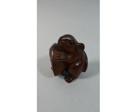 A Carved Wooden Netsuke in the Form of a Rat Carrying Carp, 5.5cm High 