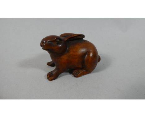 A Carved Wood Netsuke in the Form of a Recumbent Rabbit, 3cm High x 5cm Wide 