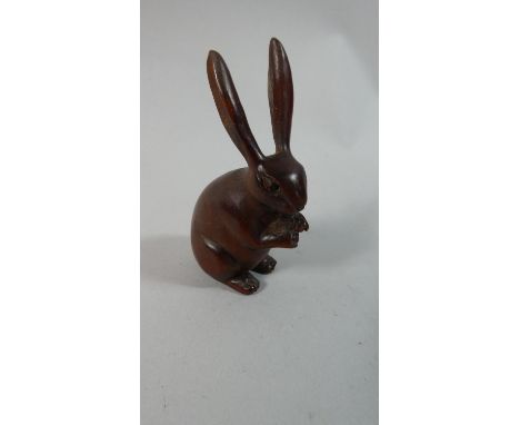 A Carved Wooden Netsuke in the Form of a Long Eared Rabbit,  7cm High 