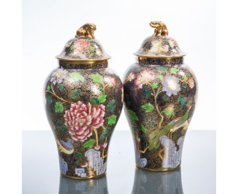 PAIR OF SPODE CHINOISERIE-STYLE LIDDED VASES
of oviform, decorated with pink and lilac flowers, birds and rocks on a dark blu