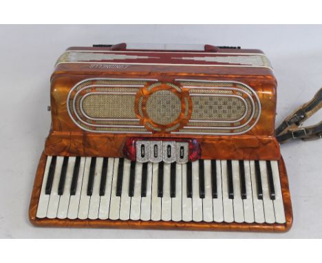 A FONTANELLA PIANO ACCORDION, in red and burnt orange