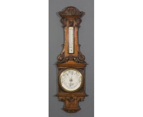 A late 19th Century oak cased aneroid barometer and thermometer retailed by W. Gregory & Co, 51 Strand, London, with 7.5ins d