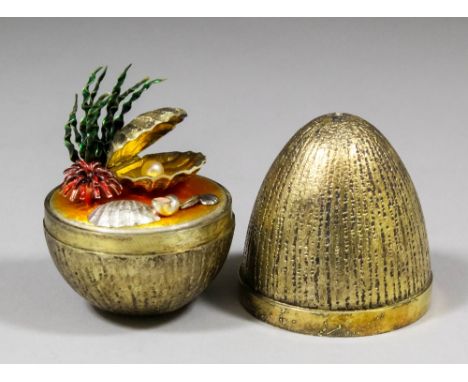 An Elizabeth II silver gilt "Mystery Easter Egg" opening to reveal various seashells including a hidden pearl, 2.75ins high b