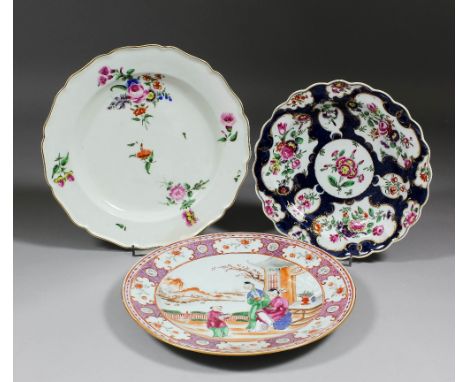 An 18th Century Worcester porcelain plate of shaped outline enamelled in colours with flowers in gilt outline reserves on a s