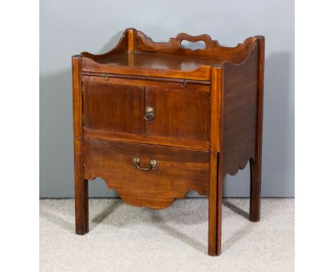 A George III mahogany rectangular tray top bedside cabinet, the shaped rim with handle cut-out to rear, fitted brushing slide