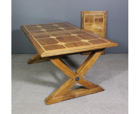 A modern inlaid hardwood rectangular extending refectory style dining table by Flagstone, with one extra leaf for same, the t