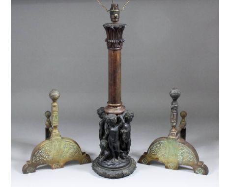 A bronze lamp base modelled in the form of four putti and a goat supporting a turned and carved Indian (?) hardwood column (t