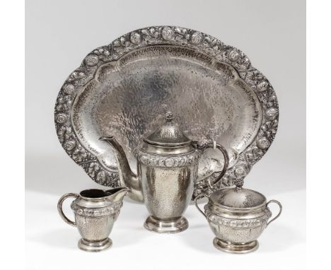 A 20th Century German silvery metal coffee service, the hammered circular bodies embossed with leaf and floral bandings, comp