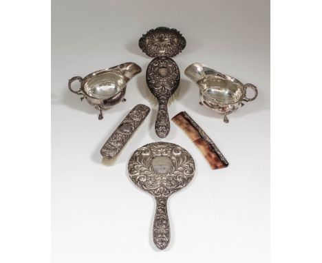 A pair of Elizabeth II silver oval sauce boats with gadroon mounts and C-scroll flying handles, each on three hoof pattern fe