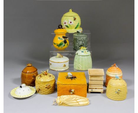A small collection of ceramic honey pots and bee related items, including - novelty jar and cover modelled as a step wooden h