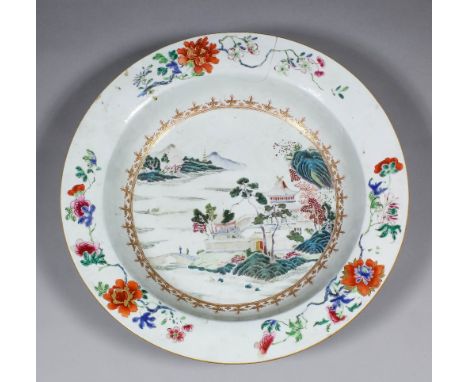 An 18th Century Chinese "Famille Verte" porcelain circular basin enamelled in colours with pavilions by a lake, 15ins (381mm)