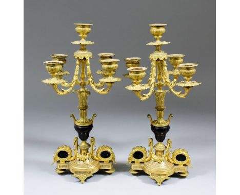 A pair of late 19th/early 20th Century Continental gilt brass five light candelabra with leaf mounts and branches, 13.75ins h