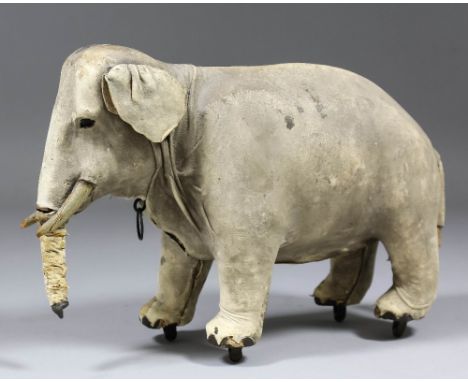 A 19th Century French automaton modelled as a standing elephant, the ring pull to neck issuing a sound, 7ins high (in poor co