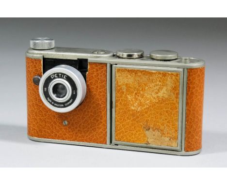 A Petie tinplate and brown leatherette camera compact, the front of the body hinged to reveal inset mirror and compact, 4.5in