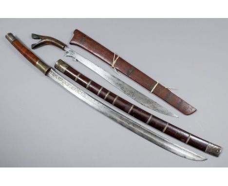 A 19th Century Burmese sabre, the 22.5ins fullered carbon steel blade decorated with incised curvilinear detail, with polishe