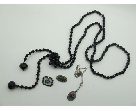 A Single Strand of French Jet (?) Flapper Style Beads, a rectangular enamel brooch, with floral detail, within bead edge bord