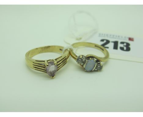 A 9ct Gold Claw Set Dress Ring, teardrop centre stone, within wide reeded shoulders (finger size O), and a 9ct gold three sto