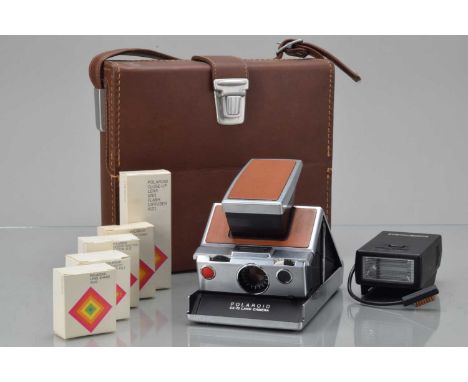 A Polaroid SX-70 Land Camera, tan, body G-VG, elements G-VG, untested, with lens shade, remote shutter button, accessory hold