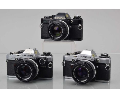 Three Olympus OM-10 SLR Cameras, one black, two chrome, shutters working, responsive in auto, one with working manual adapter